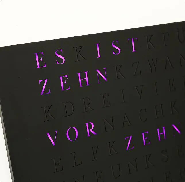 Wortuhr with illuminated purple letters